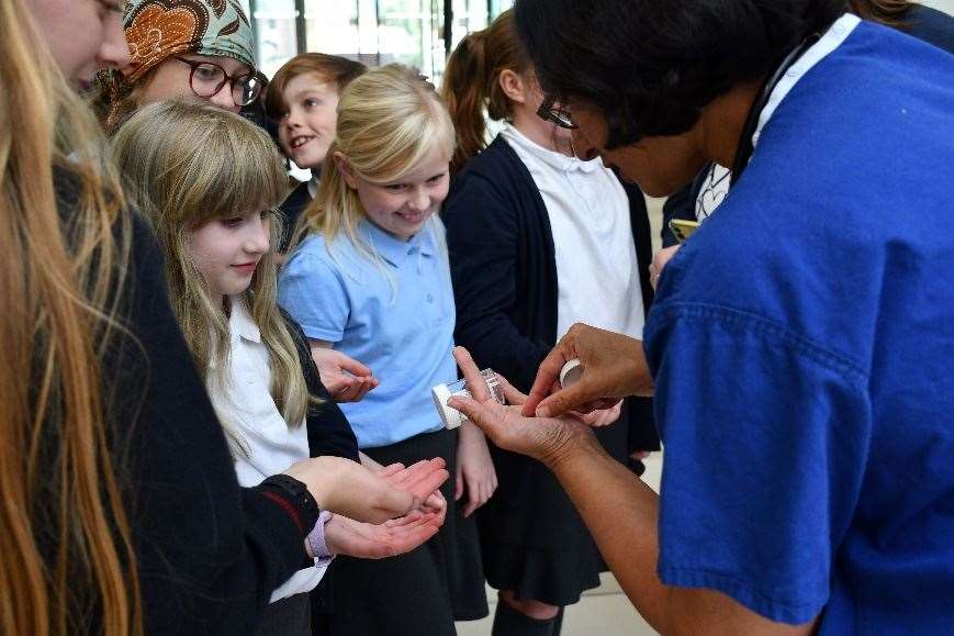 Dr Braganza showing pupils examples of stents used in an angioplasty