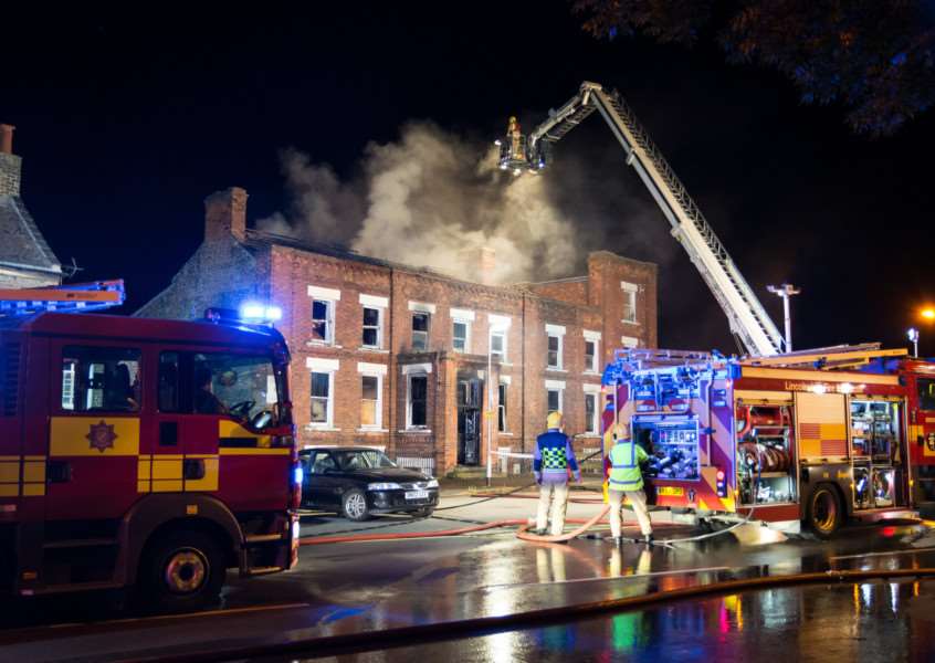 Smoke billows from the hotel as firefighters work from above. Photo: Dave Hudson Photography ANL-160814-132251001