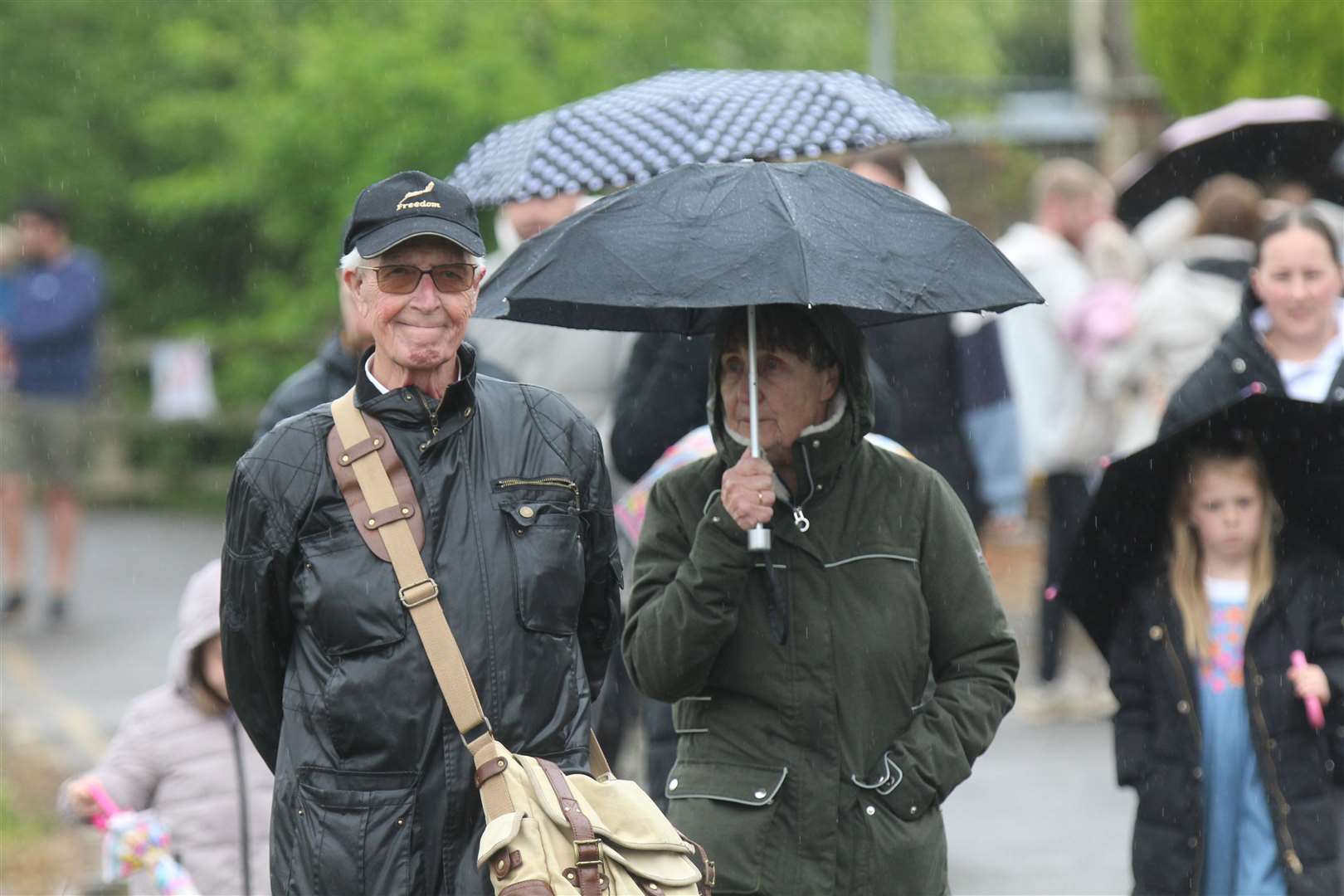 The community turned out with umbrellas to watch the race. Picture: Robert Windle RWT Photography
