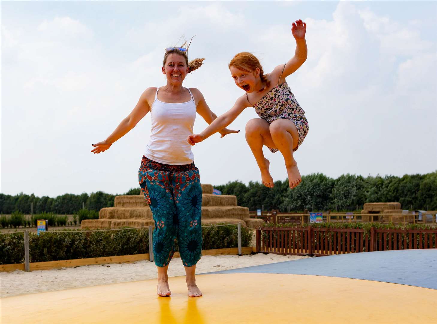 Families enjoying the "bouncy pillow" on the beach area. Picture: Terry Harris