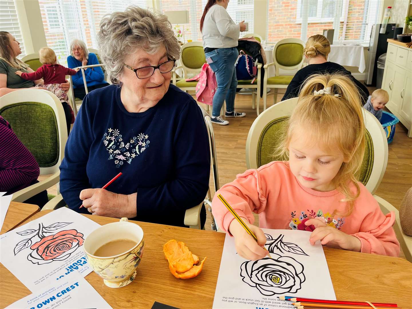 Evie and resident, Betty creating St George's Day Roses