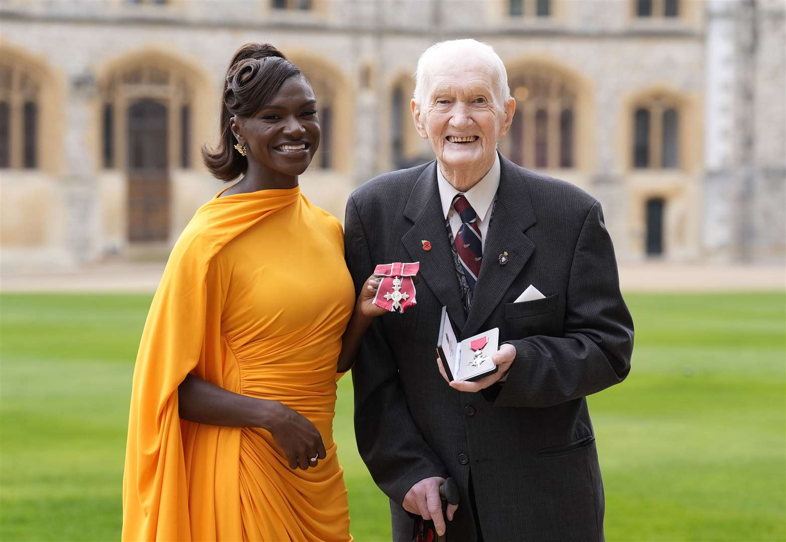 Dina Asher-Smith alongside George Kelly, former president of the St Ives branch of the Royal British Legion, after being made MBEs by the King at Windsor Castle (Andrew Matthews/PA)