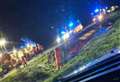 Bus containing schoolchildren crashes and overturns into water-filled ditch