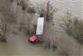 Driver rescued by firefighters after lorry became stranded on flooded road