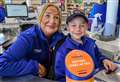 Young supporter Johnathon takes turn on Tesco till for RNLI