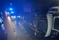 Overturned car sees village road closed