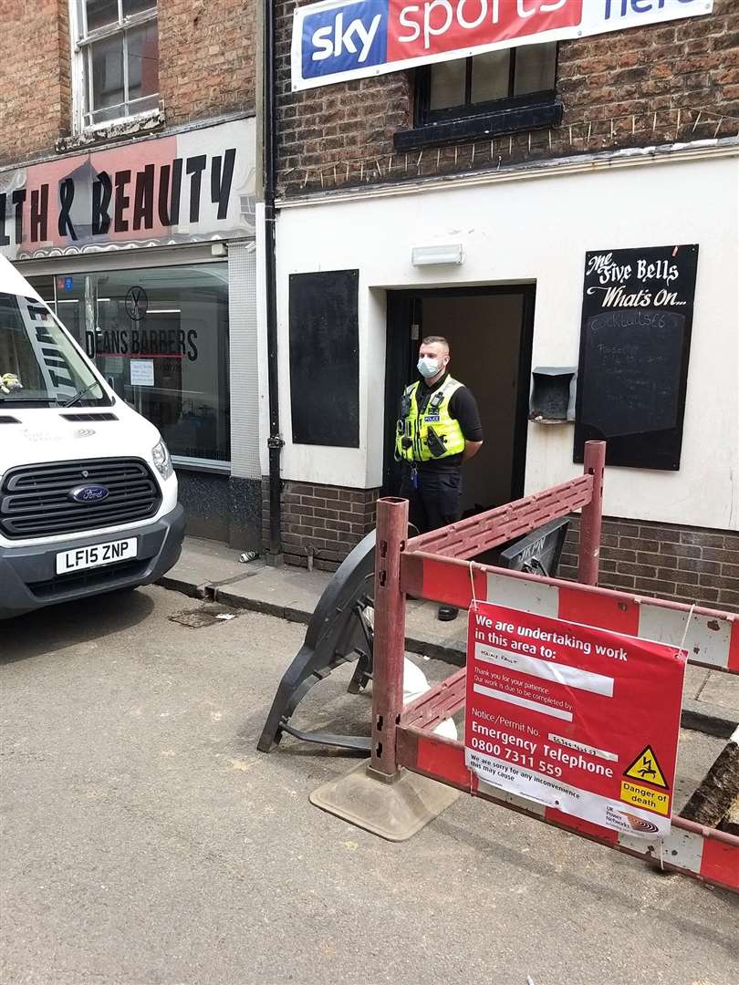 A police officer guarding the entrance to the old Five Bells pub in Wisbech (47703775)