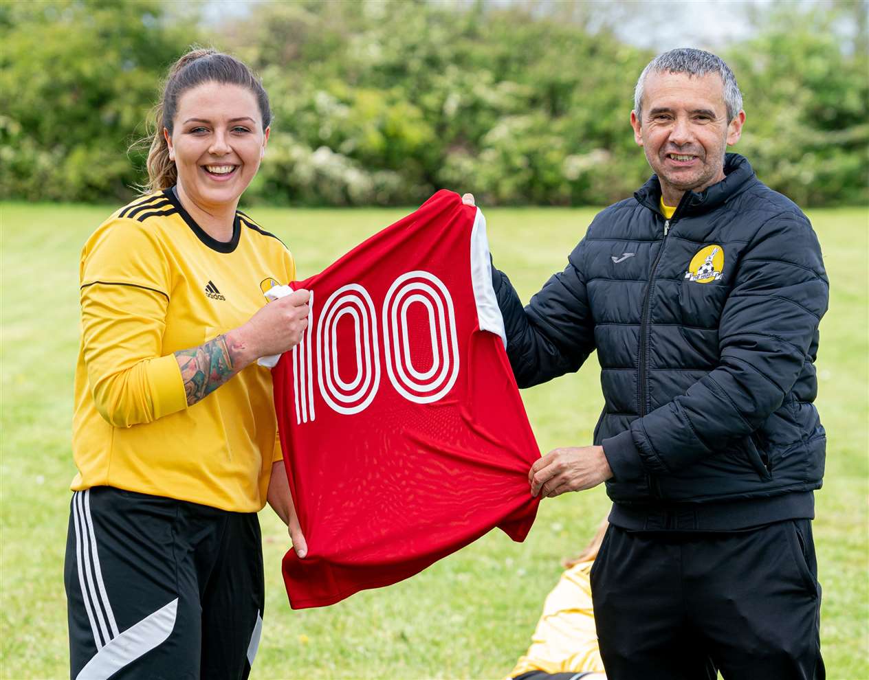 Adele Munday played her 100th game for the Hares and gets her centenary shirt from manager Gary Davis.Photo: STEVE HONE (47490886)