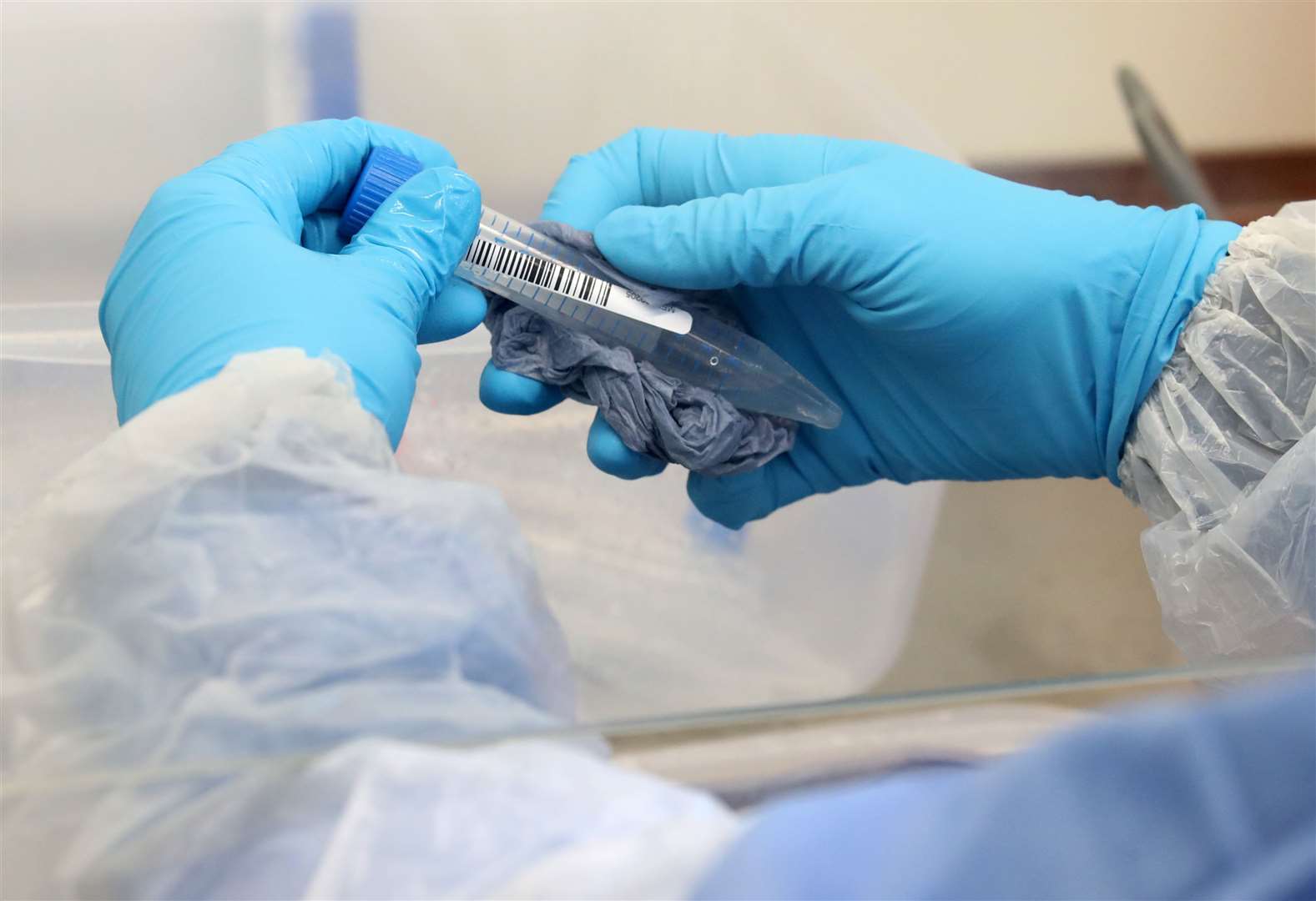 A test tube is cleaned on arrival at the new Covid-19 testing lab. (39108991)