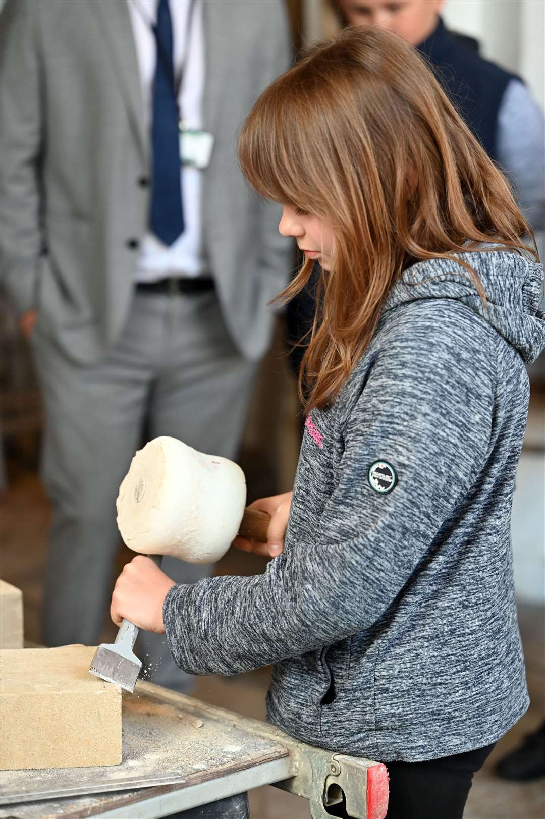 Pupils try their hand at stone masonry.