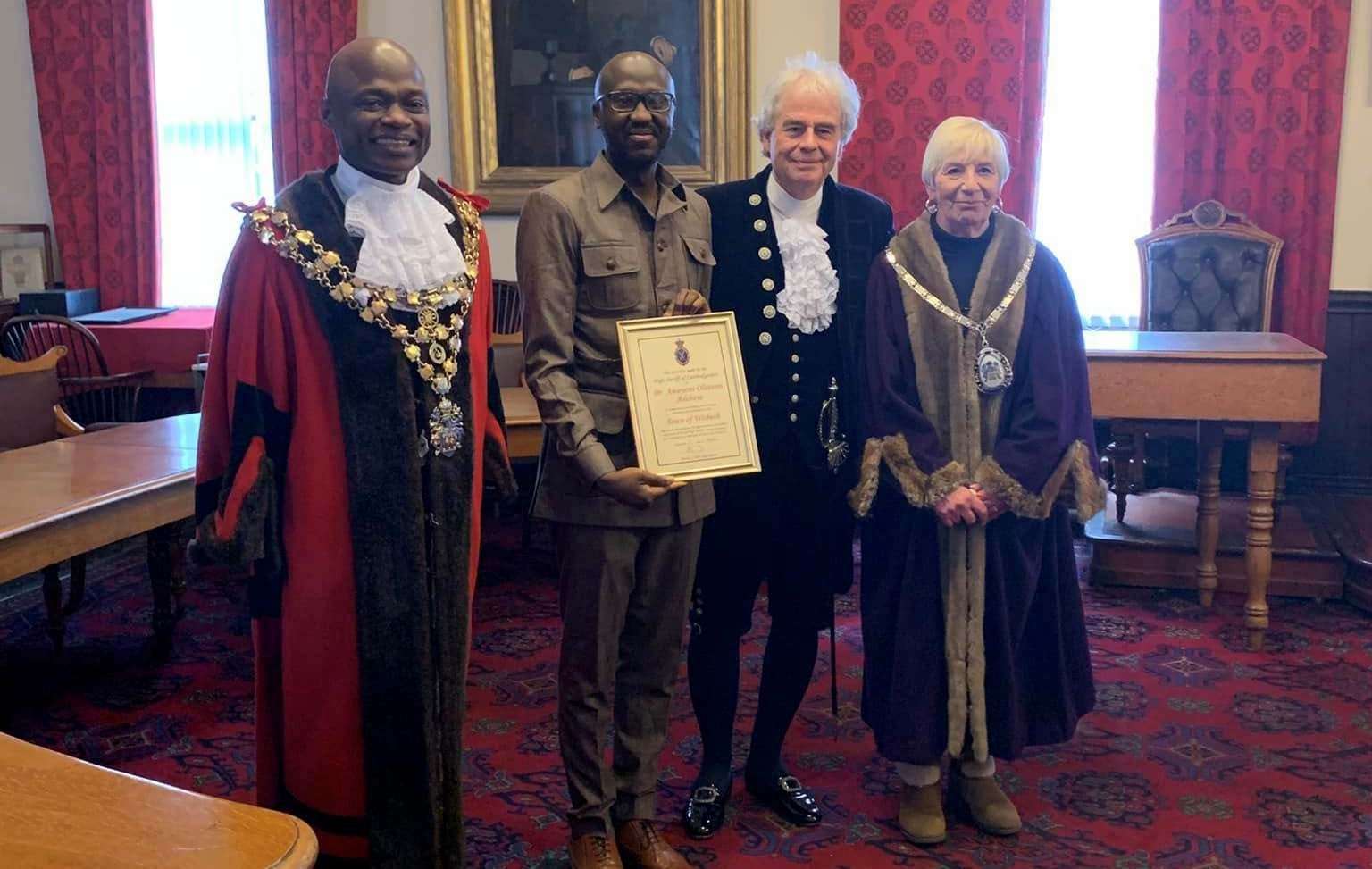 Dr Olutsin Awoyemi with his certificate pictured with the mayor Cllr Sidney Imafidon, the High Sheriff, David Way, and deputy mayor Janet Tanfield