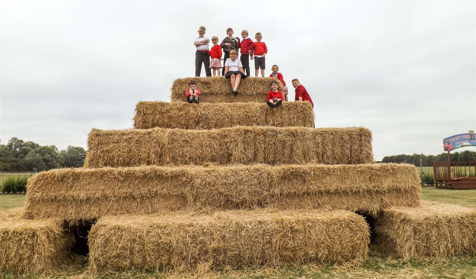 A giant straw bale mountain proved a challenge for pupils from Guyhirn school as they helped launch the Skylark maize maze and other attractions at the site. (3047074)