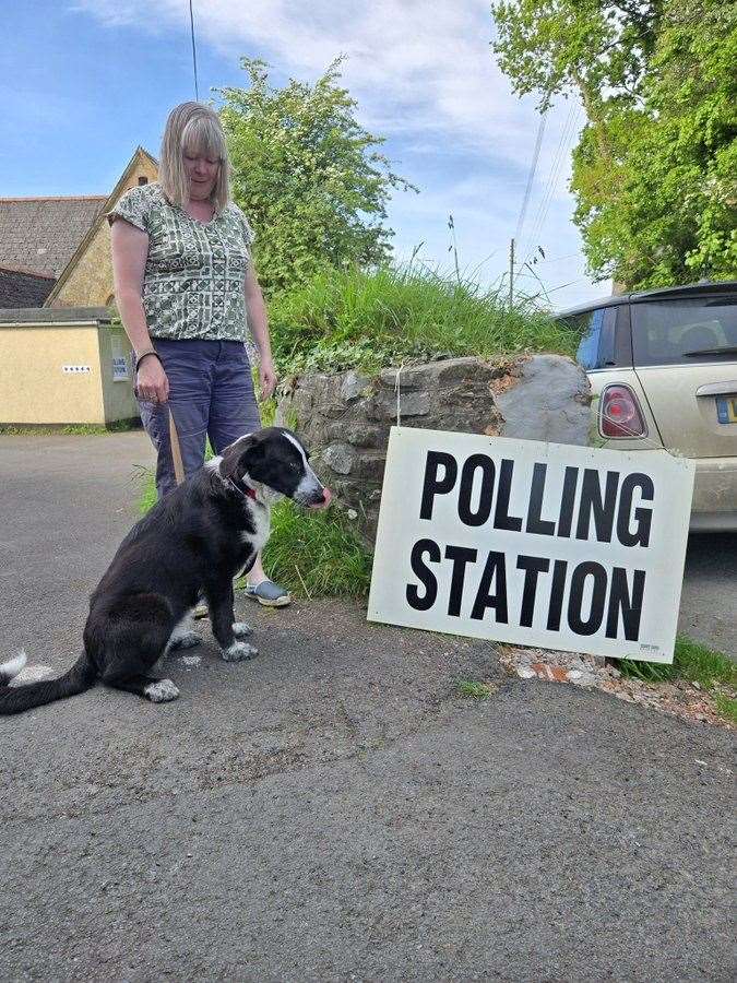 Nellie, a six-month-old Romanian rescue dog, with her owner Saran Evans, outside a polling station in Winkleigh, Devon (Bruce Evans/PA)