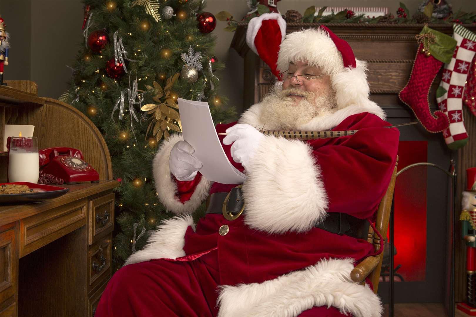 He's reading the reviews of festive films, including Die Hard.