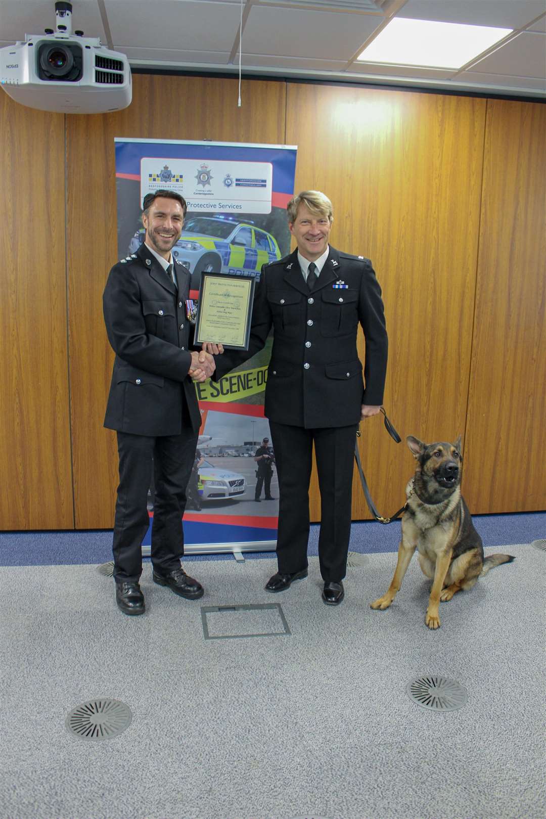 Chief Inspector Robin Sissons (left) awarding the certificate to PC Clive Warncken and police dog Max (6158645)