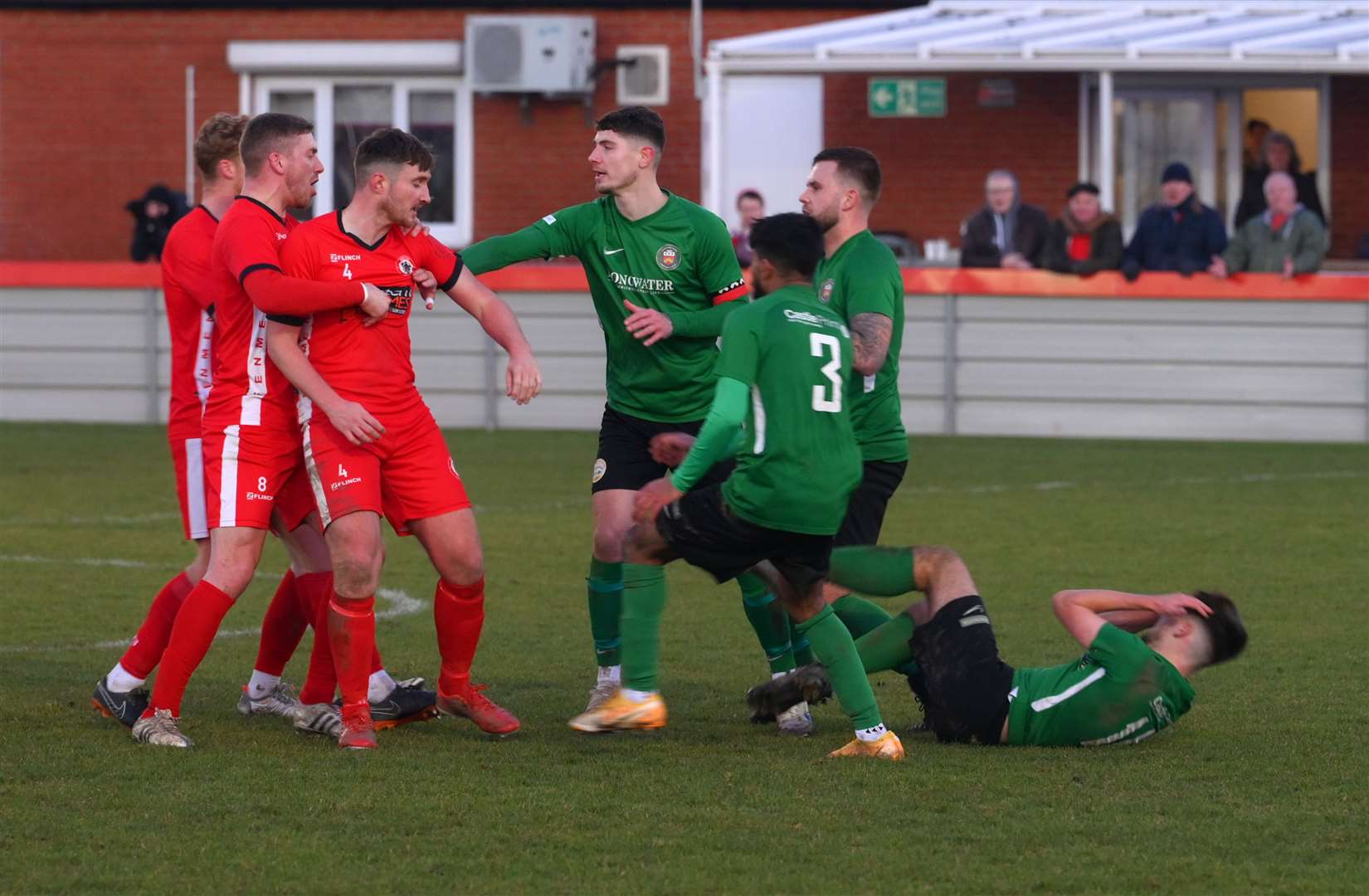 Sleaford's Lewis Daff goes down holding his head after being pushed in the chest