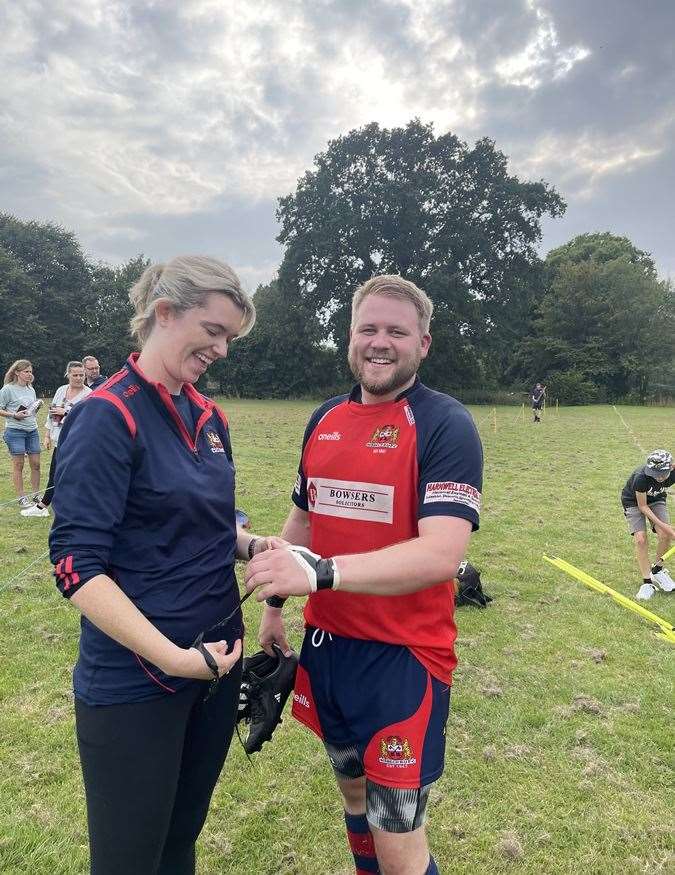 Team hhysio Lyndsey Wright post-match assessing a smiling Mojo’s injury