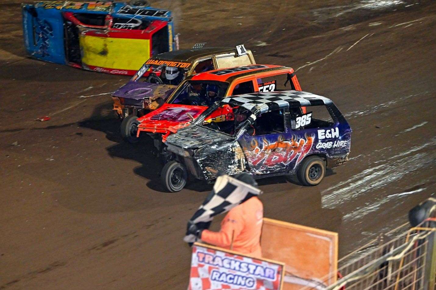 85 Roy Gedge just takes the chequered flag in the Reliant Robins from 553 Daniel Douglas and 1 Lee Waddington in one of the tightest finishes of the night – whilst fellow Wisbech racer 106 Olly Betts can be seen in the background on his roof. Picture: Jim Harrod
