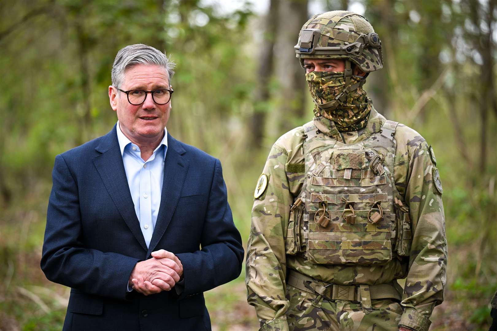 Prime Minister Sir Keir Starmer stands next to a New Zealand soldier during a visit to a military base during a visit to a military base training Ukrainian troops in the West of England (Finnbarr Webster/PA)
