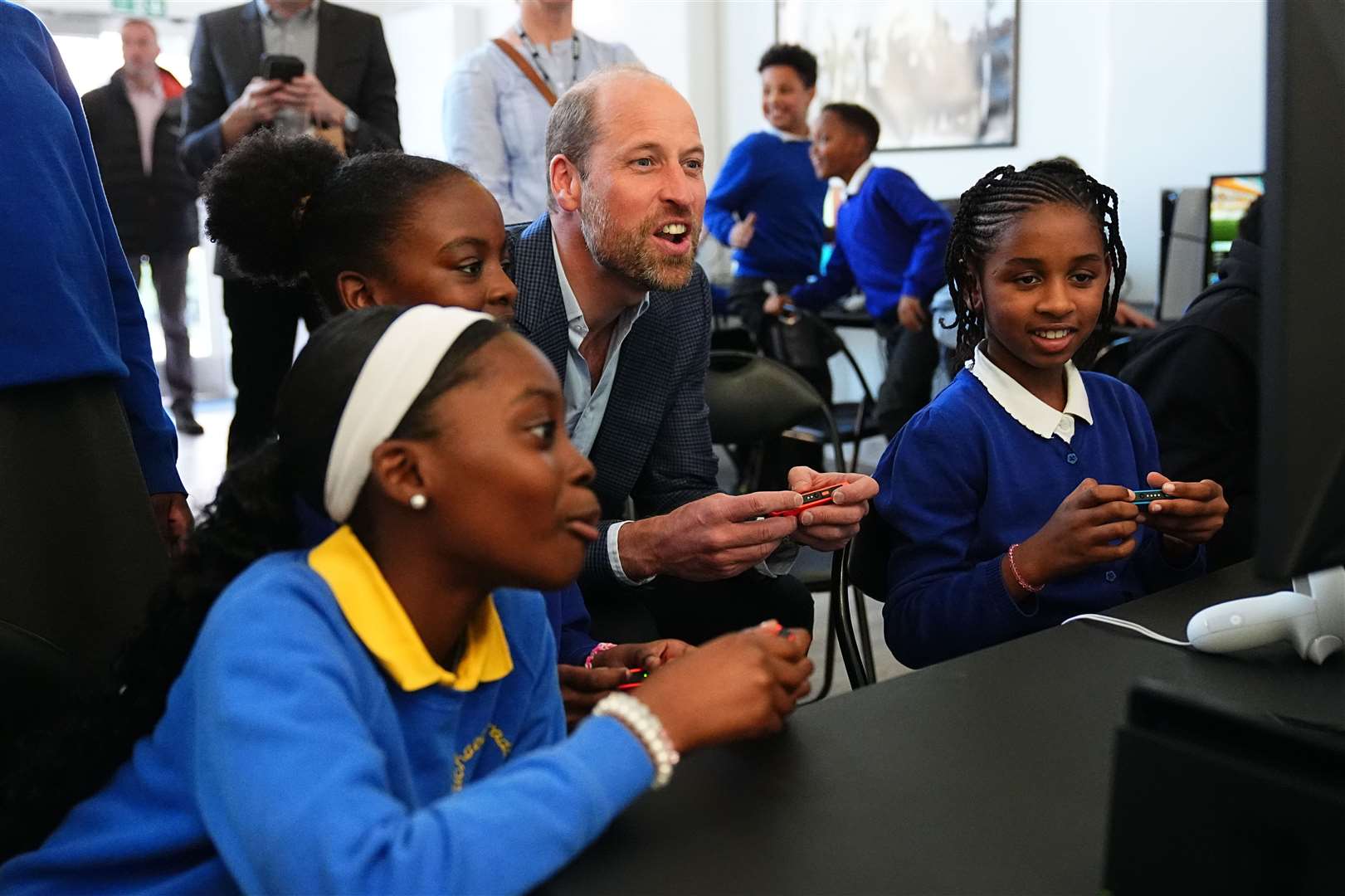 The Prince of Wales plays a computer game during a visit to the Mentivity community centre and youth hub in Southwark (Aaron Chown/PA)