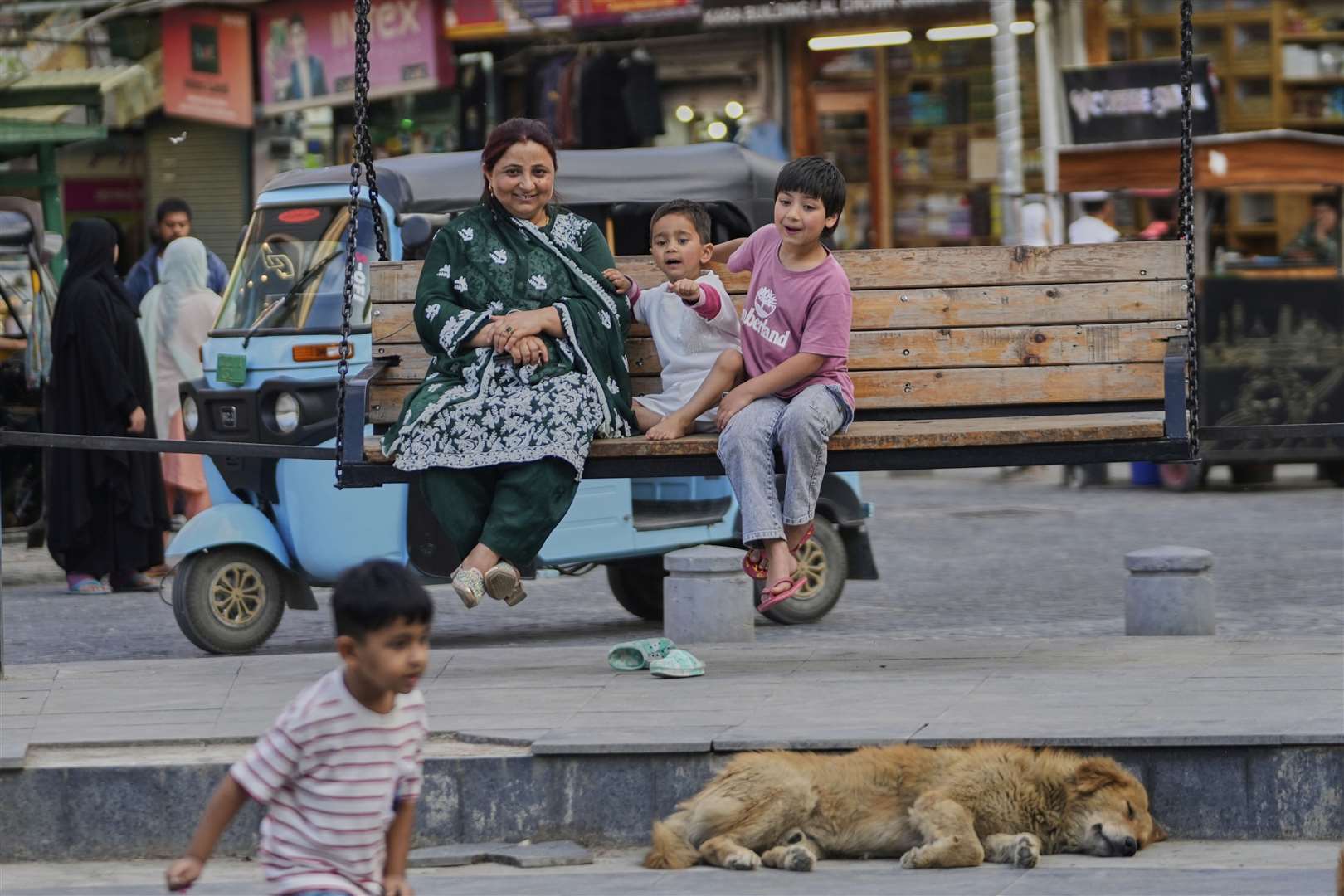 A woman and her children in Srinagar, in Indian controlled Kashmir after a fragile ceasefire was announced on Saturday (AP Photo/Mukhtar Khan)