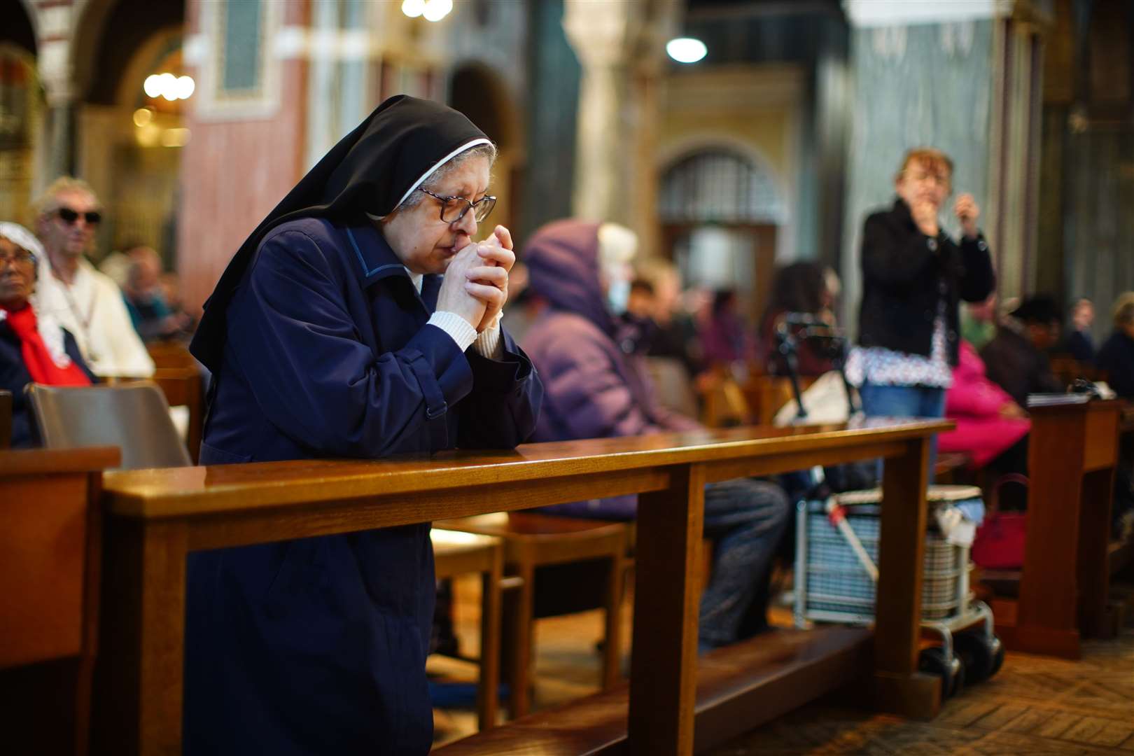 A nun prays in Westminster Cathedral in central London following the announcement of the death of Pope Francis (James Manning/PA)