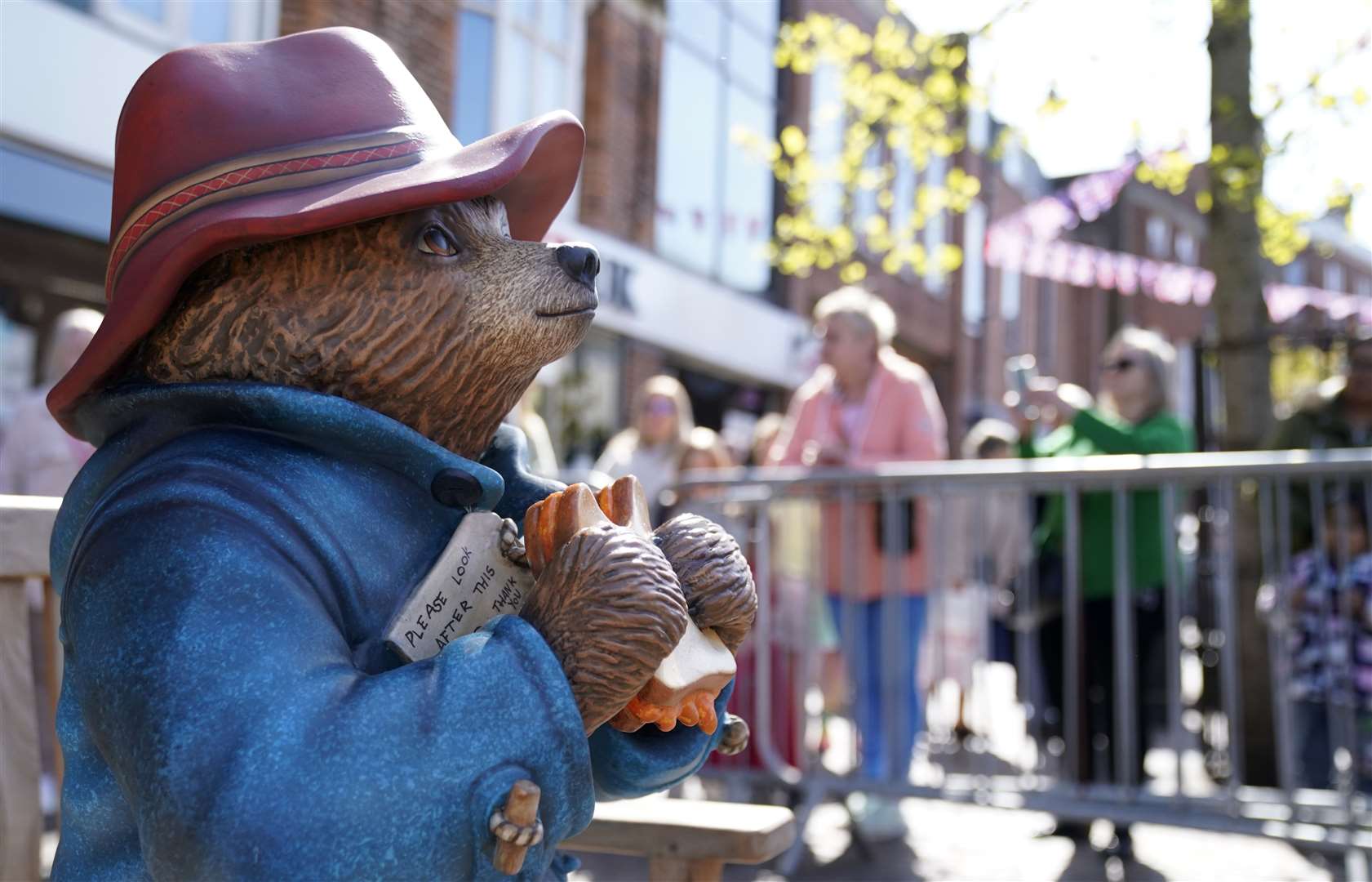 A repaired and repainted statue of Paddington Bear is returned to its home (Andrew Matthews/PA)