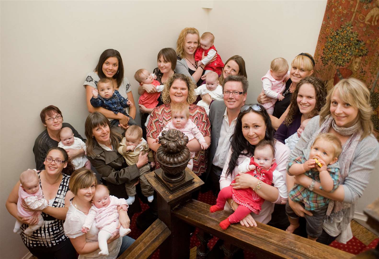 Louise Brown (centre), the world’s first IVF baby, at Bourn Hall with a group of babies born as a result of NHS treatment. Also pictured is Mike Macnamee, Bourn Hall's chief executive. (13249186)