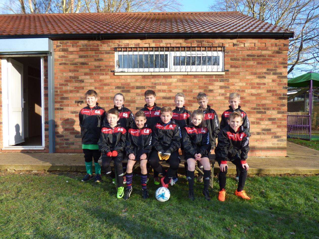 Tydd FC under 9s sponsorship from three local companies: Lee Wayman and team at Waymans Transport sponsored the rain jackets. (2571577)
