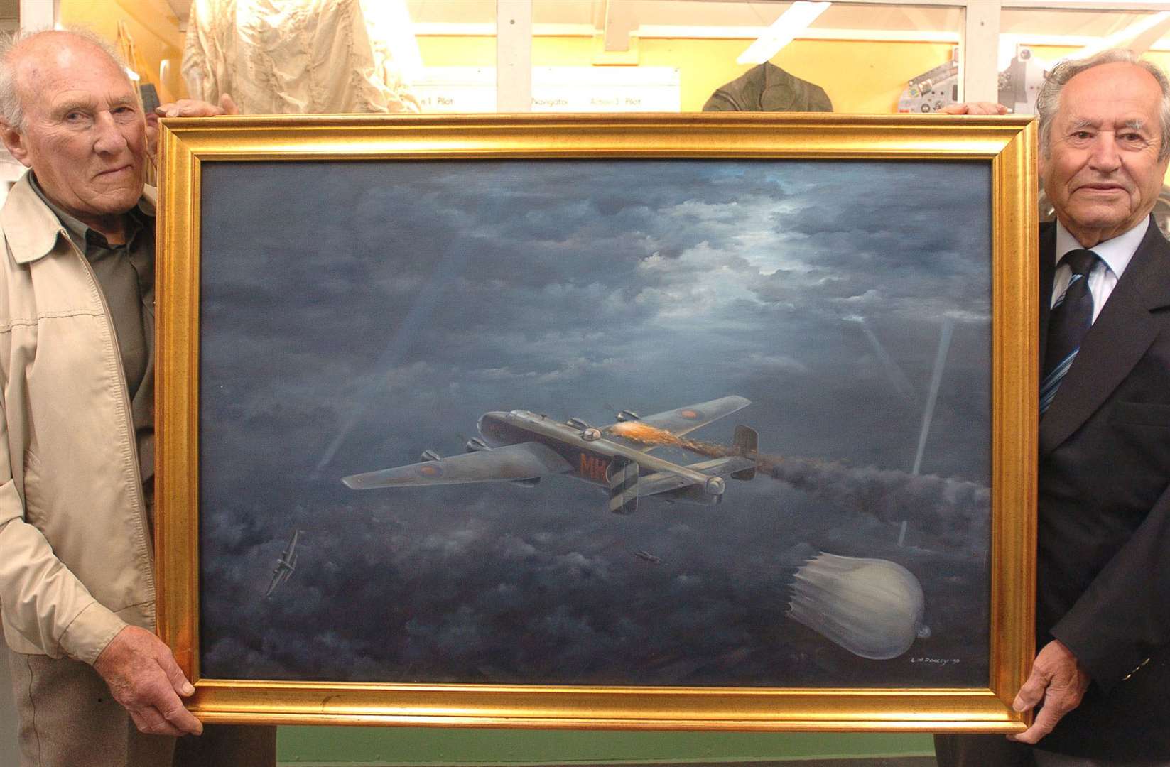 Henry Wagner (left) with artist Les Pooley and his original painting depicting Henry's Halifax bomber being shot down.