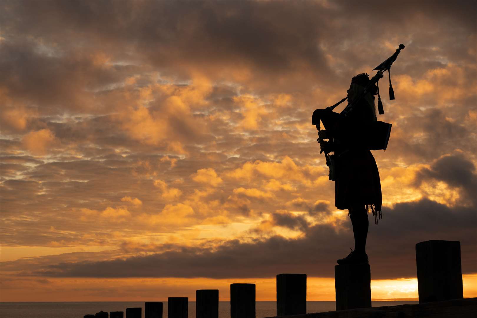 Scotland’s National Piper Louise Marshall playing a lament to the fallen at dawn on Portobello Beach in Edinburgh (Jane Barlow/PA)