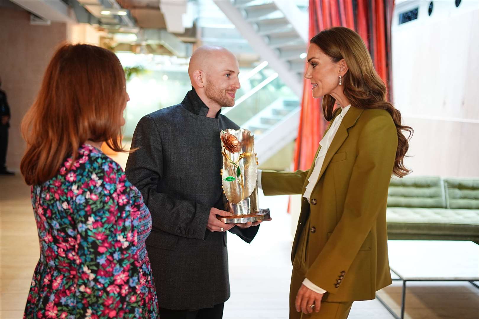 The Princess of Wales presented the Queen Elizabeth II Award for British Design to designer Patrick McDowell (centre) accompanied by his mother (Aaron Chown/PA)