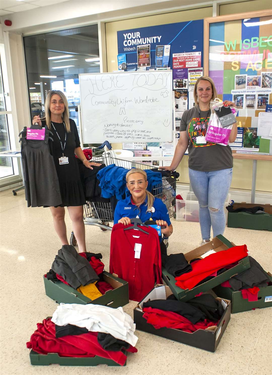Community Uniform Wardrobe at Tesco Exspress in Wisbech. Pictured Julie Bushby (Tesco Community Champion) Monika Mazeikaite. Haley Wynn.. (58651783)