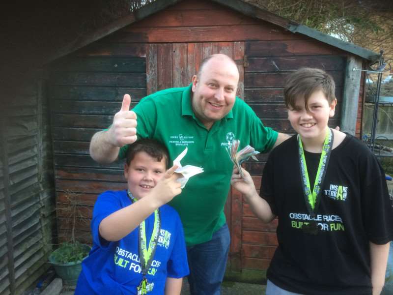 Owen, 12, and Jamie, 8, Burge with Macmillan FC manager Justin Cross.