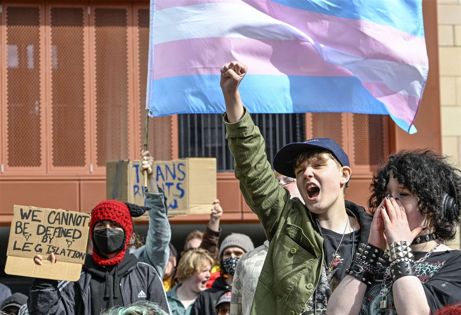 People from trans rights groups and community organisations take part in a rally organised by Resisting Transphobia outside Queen Elizabeth House, the UK Government building in Edinburgh (Lesley Martin/PA)
