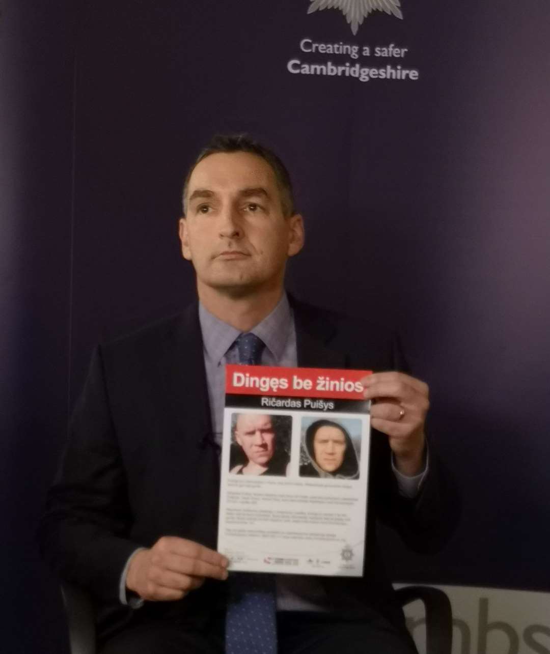 Supt Adam Gallop with one of the posters were put up around Wisbech in a bid to close the mysterious case of Ricardas Puisys.
