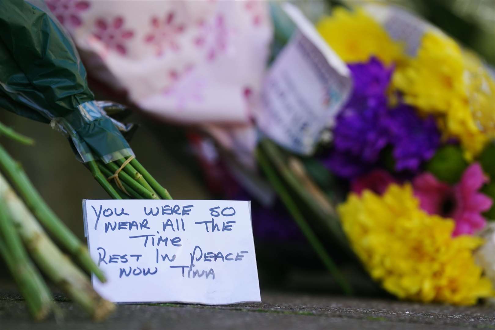 Flowers and messages left near to the scene in Youghal, Co Cork, where Tina Satchwell’s body was found (Brian Lawless/PA)