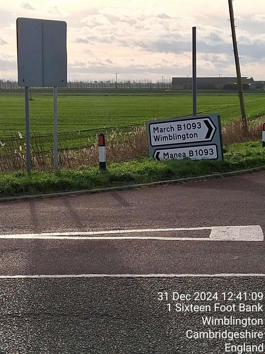 Drivers have difficulty reading the directional sign as it has fallen down the post