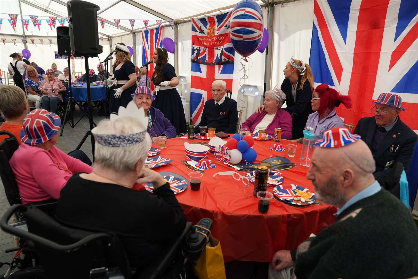 Staff and veterans dance at a tea party (Andrew Milligan/PA)