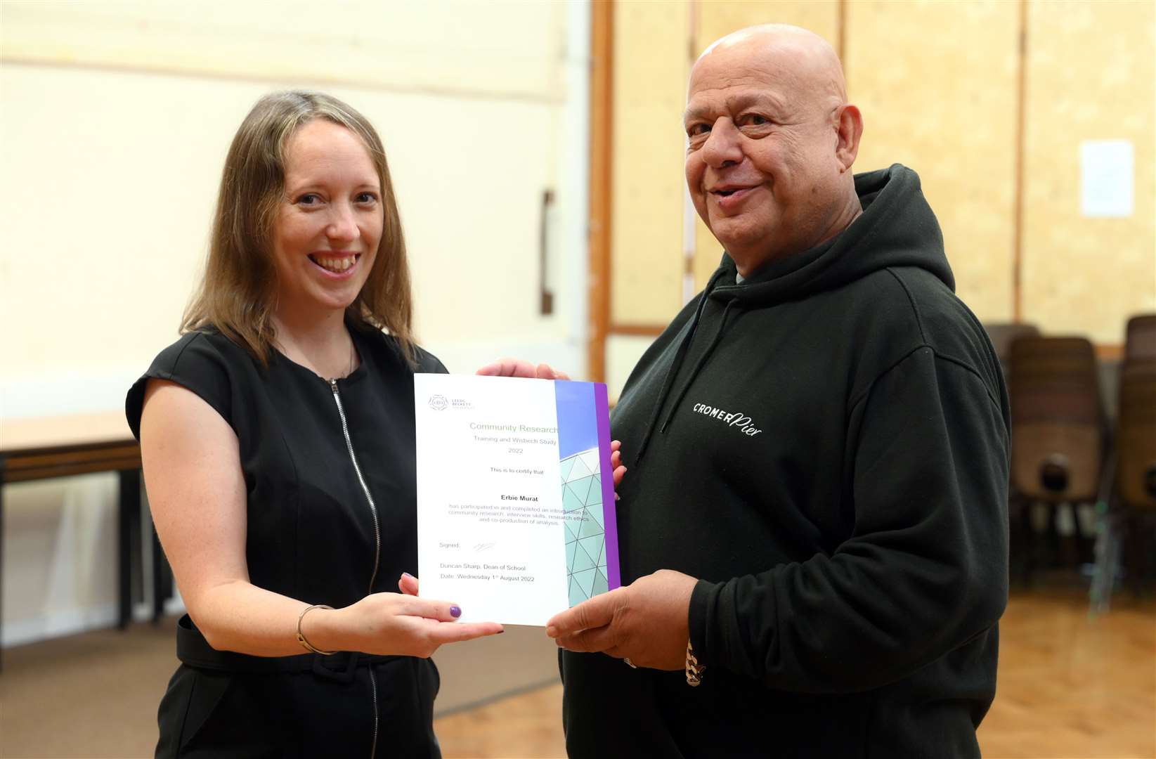 Erbie Murat receives his certificate for the work he did on the project.
