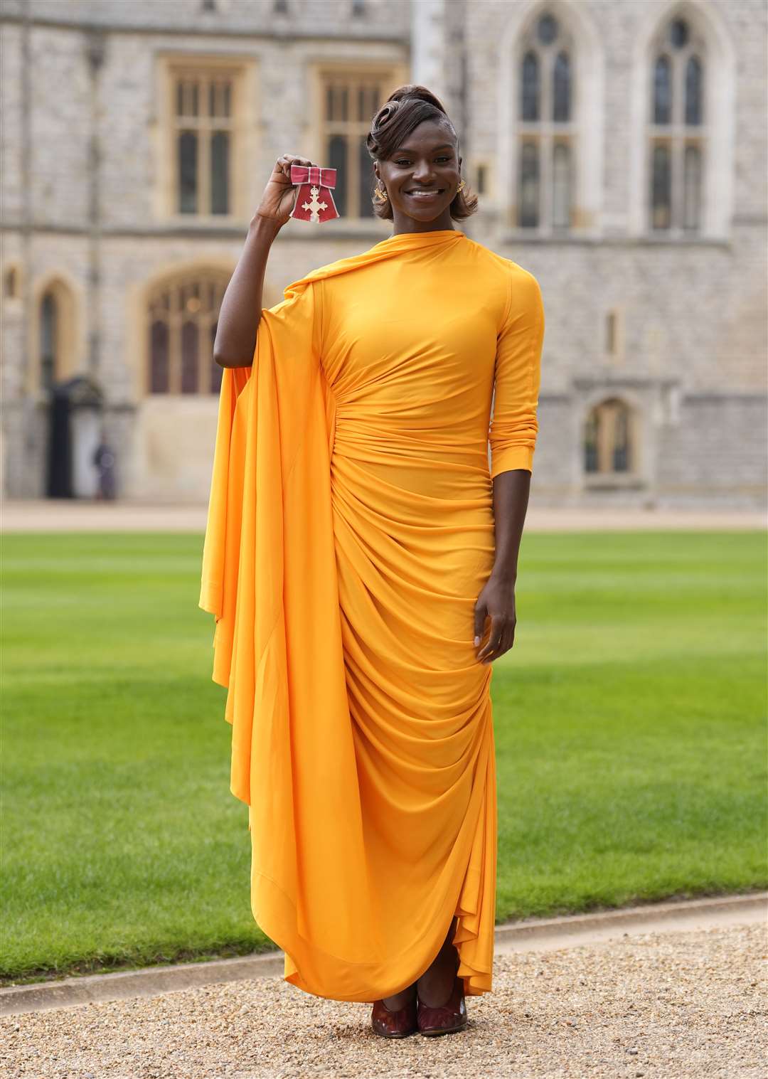 Dina Asher-Smith after being made a Member of the Order of the British Empire by the King at an investiture ceremony at Windsor Castle (Andrew Matthews/PA)