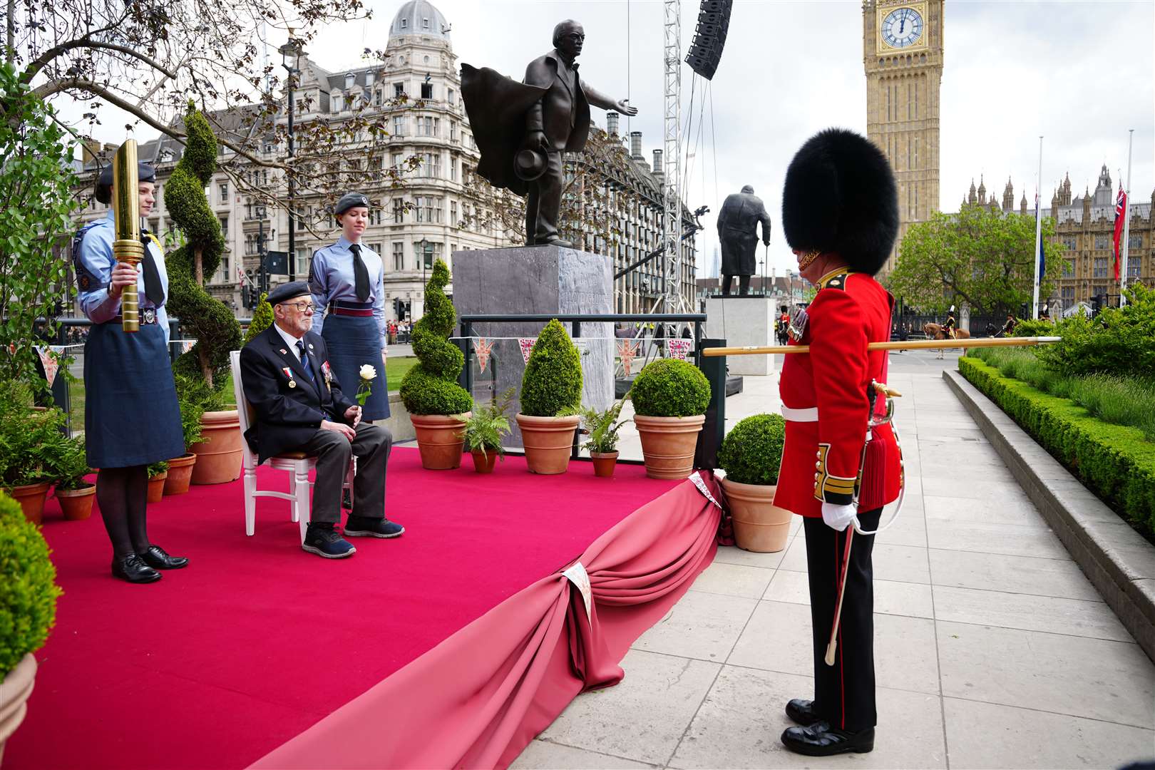 Second World War veteran Alan Kennett receives a peace rose near Parliament Square ahead of a military procession (Jeff Moore/PA)