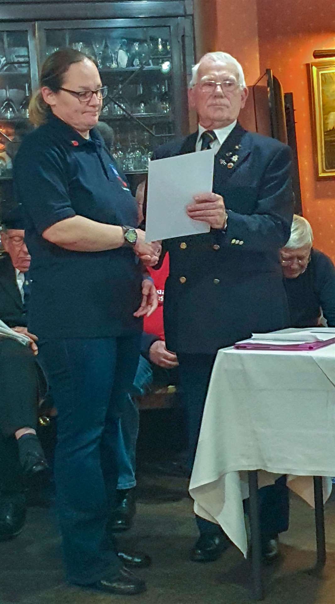 Major Larke presents a certificate of gratitude to Tina Prior.