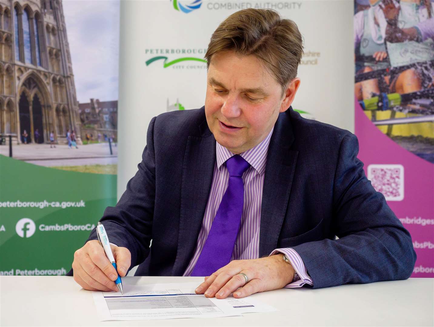 Mayor Dr Nik Johnson signing the decision notice confirming he has chosen franchising for Cambridgeshire and Peterborough's bus network. Picture: Combined Authority.
