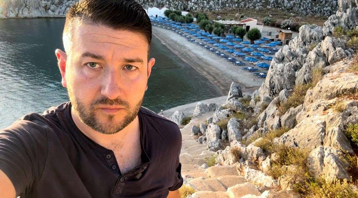 Journalist David Blackmore pictured with St Nicholas beach behind him. This is the beach Dr Mosley set off from on his fateful walk. Photo: David Blackmore.