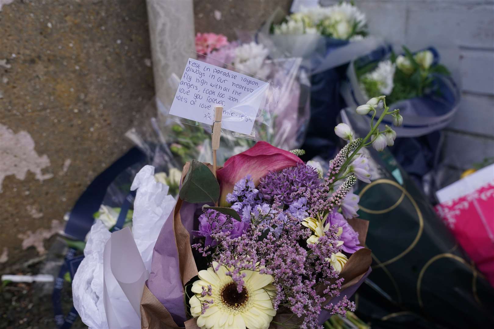 Floral tributes left by the gates of Fairfield Industrial Park(Owen Humphreys/PA)