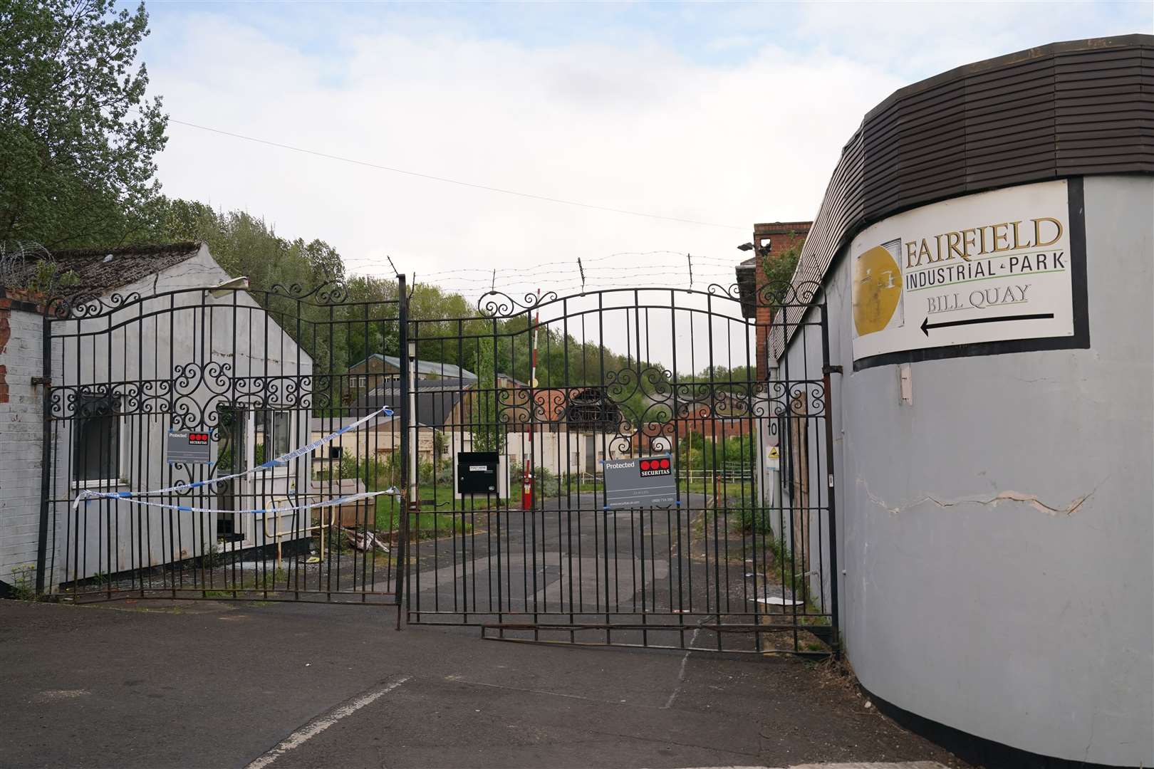 Police tape on the gates of Fairfield Industrial Park (Owen Humphreys/PA)