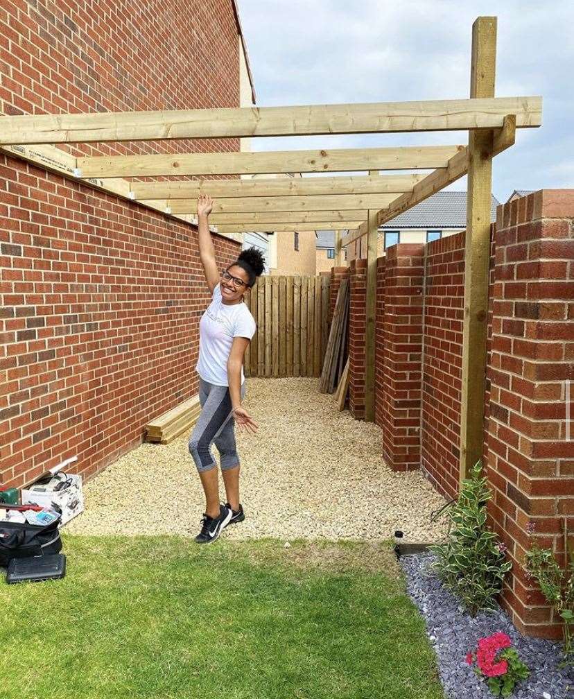 Shade with a pergola she has been building in her garden