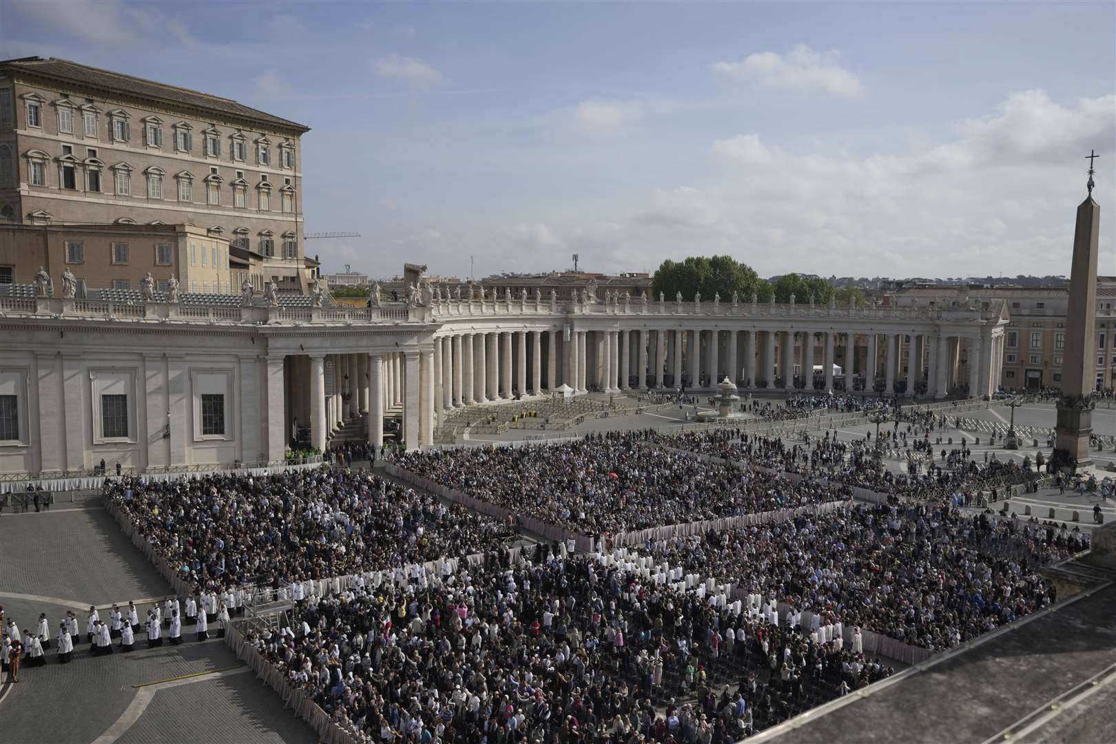 People gather in St Peter’s Square as they await the arrival of the body of Pope Francis (Markus Schreiber/AP)