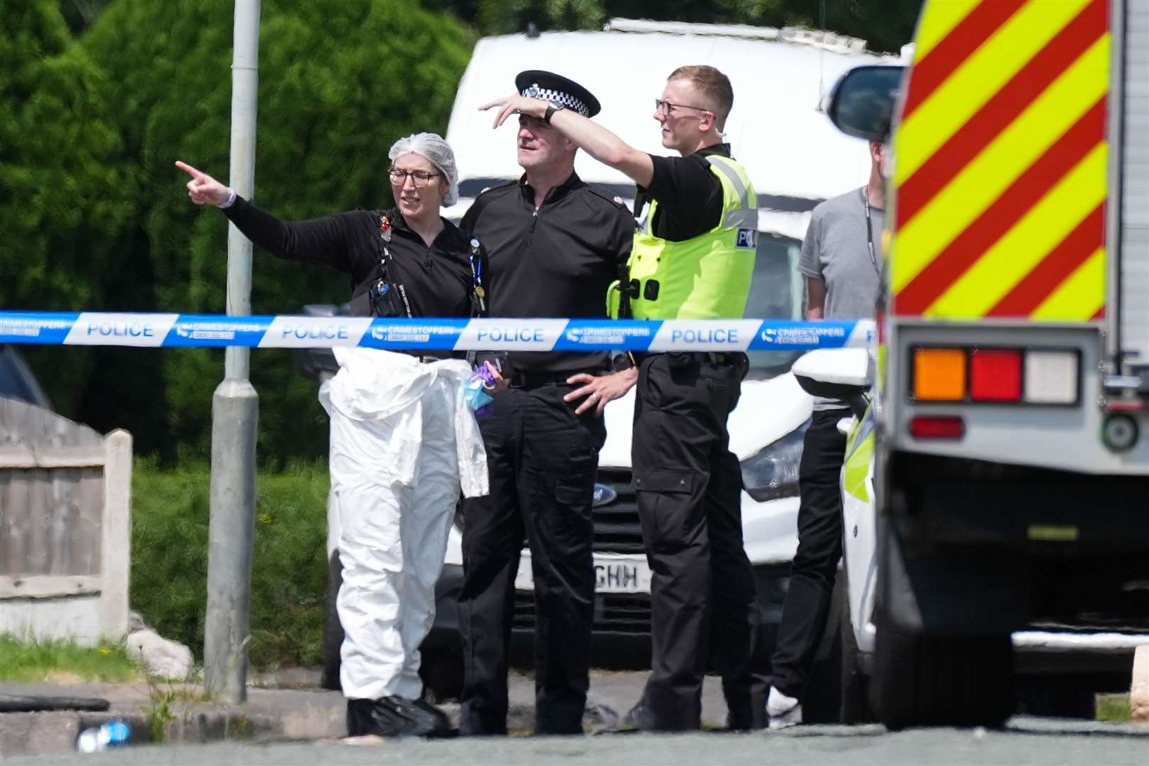 Emergency services at the scene hours after the fire (Jacob King/PA)